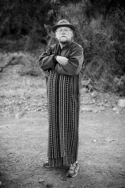 Black and White image of Poet wrapped in Mexican  blanket